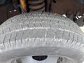 Close-up view of a tire from a 2004 Ford F-350 SD showing tread pattern and wear details