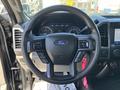 Steering wheel of a 2022 Ford F-350 SD featuring control buttons and a central Ford logo