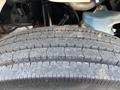Close-up of a rugged tire tread from a 2019 Freightliner M2 106 showing deep grooves and worn surface patterns