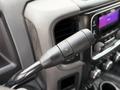 A close-up view of the gear shift lever of a 2013 RAM 3500 showcasing the controls on the handle and surrounding dashboard elements