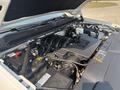 Close-up of the engine compartment of a 2017 Chevrolet Silverado 1500 showing various components including the engine block battery and air intake system