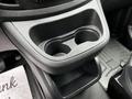 A close-up of the cup holder area in a 2020 Mercedes-Benz Metris featuring dual cup holders and a textured surface around them