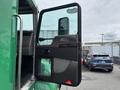 A 2013 Kenworth T370 truck door partially open showing the interior features and controls