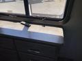 A 2021 Grand Design Recreational ST3478MBS featuring a countertop with a remote control placed on it