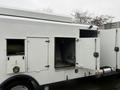 A white 2014 International TerraStar with a side door open revealing equipment inside and a hose visible in an adjacent compartment