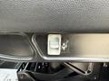 A close-up of a control lever on the driver side of a 2022 International MV607 vehicle with an illustration of a cupholder next to it