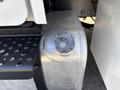 Close-up of the fuel tank cap on a 2005 Freightliner M2 106 showing a metallic surface with some dirt and wear
