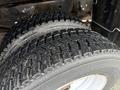 Close-up of a heavy-duty tire mounted on a 2011 Dodge Ram 5500 showing deep tread patterns and wear indicators