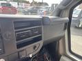 The interior dashboard of a 2018 Chevrolet Express with air vents and a compartment for controls and storage