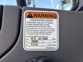 Warning label on a 2019 Freightliner M2 106 indicating overheating hazards and operational limits for GPM and PSI