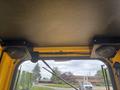 Interior view of a 2004 Bombardier SW48 showing ceiling speakers mounted on either side and overhead structure without any visible controls or instrumentation