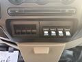 Control panel of a 2009 Ford F-550 featuring buttons for auxiliary functions and air conditioning controls