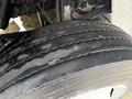 A close-up of a worn tire on a 2019 Freightliner M2 showing visible tread wear and slight cracks on the surface