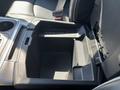 Interior compartment of a 2018 RAM 3500 with divided sections for storage and a textured base