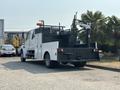 A 2006 Sterling Acterra truck with a black utility bed and a hydraulic crane attached to the back