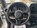 Steering wheel of a 2020 Mercedes-Benz Sprinter 2500 featuring the Mercedes-Benz logo and various controls with gauges visible in the background