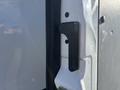 Close-up of a black door handle on the side of a 2024 Mercedes-Benz Sprinter 2500 van