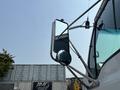 A side view mirror of a 2006 Sterling Acterra truck showing a reflective surface and a circular convex mirror