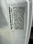 A white sticker with vehicle noise emission control information for a 2003 Ford Motor Company vehicle with details about regulations and compliance