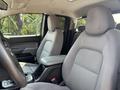 Interior of a 2017 Chevrolet Colorado featuring two front seats with gray fabric upholstery and a center console between them