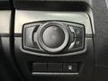 Control panel of a 2019 Ford Explorer with a round knob for headlights and various switches for interior lighting and locking functions