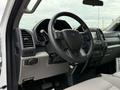 Interior view of a 2022 Ford F600 showcasing the steering wheel dashboard controls and seat upholstery