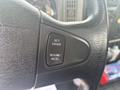 Close-up of the cruise control buttons on the steering wheel of a 2012 International 7300 Workstar showing options for set resume and accelerate