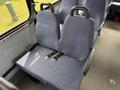 Two seats with blue fabric upholstery and seatbelts in a 2017 Chevrolet Express vehicle interior