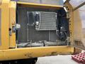 A 2018 John Deere 350 machine with its engine compartment open displaying metal components and cooling systems