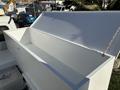 A large, empty white storage compartment with a hinged lid on the back of a 2005 Freightliner M2 106 truck