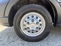 A close-up of a silver wheel on a 2025 Ford Transit T-350 featuring a multi-spoke design and a durable tire with visible tread patterns