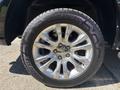 Close-up of a chrome wheel rim with a silver five-spoke design and a black tire labeled Duratrac 275/60 R20 on a 2015 RAM 1500
