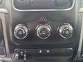 The image shows the control panel of a 2016 RAM 1500 featuring three climate control knobs and additional buttons for towing and other functions
