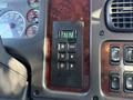 Close-up of the gear shift control panel in a 2011 Freightliner M2 106 featuring buttons for various driving modes and an indicator display