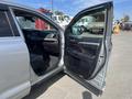 A 2018 Toyota Highlander with the driver's side door open revealing the interior features and seating area