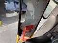 A 2018 Chevrolet Express interior featuring a fire extinguisher mounted on a vertical support in the passenger area with adjacent seating visible