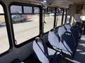 A 2017 Chevrolet Express with a spacious interior featuring blue fabric seats and large windows showcasing the vehicle's design and layout