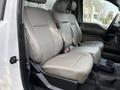 A 2017 Ford F-350 SD with a spacious front interior featuring gray leather seats and a console between the front seats