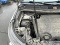A 2016 Ford Explorer with a dirty engine compartment showing various components including a battery and fluid reservoirs