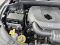 Close-up view of the engine compartment of a 2015 Dodge Durango showcasing the V6 engine and various components such as the battery and coolant reservoir