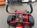 A 2017 Ferris Rotary lawn mower with a red frame large front and rear wheels control panel and handlebars in the foreground