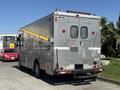A silver 2009 Morgan Olson Workhorse W62 with a ladder on the roof and various equipment on the sides