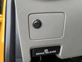 A close-up view of a control panel featuring a circular button and a brake release button in a 2017 Ford F-250 SD interior