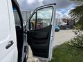 2022 Mercedes-Benz Sprinter van with an open sliding door showcasing the interior and driver's seat
