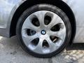 A close-up of a silver alloy wheel on a 2004 BMW 6-Series featuring large spokes and the BMW logo in the center of the hub