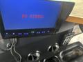 A black monitor displaying "NO SIGNAL" in red text with a remote control and two circular vents below it