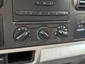 Controls for climate and audio system in a 2007 Ford F-550 with dials for temperature and fan speed