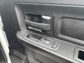 Close-up of the interior door panel of a 2016 RAM 1500 showing the handle and window control buttons
