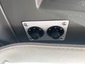 Control panel with two circular knobs mounted on a metal plate
