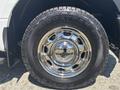 Close-up of a chrome wheel rim and tire from a 2019 Ford F-150 showcasing the tire tread and reflection in the rim